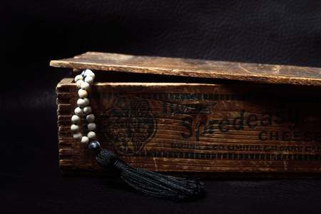White beaded necklace in a vintage wooden box