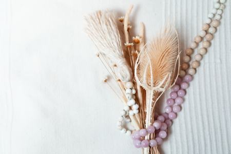 Beaded purple Kunzite and cream colored Riverstone crystal necklace wrapped around small flowers